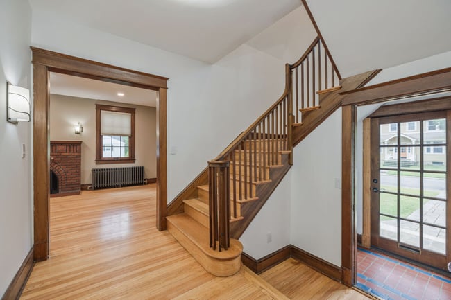 Traditional floorplan showing stairs entering on the right side with a hallway leading into a dining room on the left.